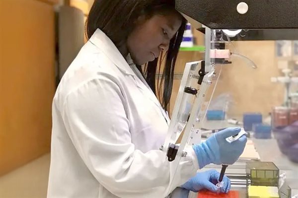 Student working with syringe and test tube in lab