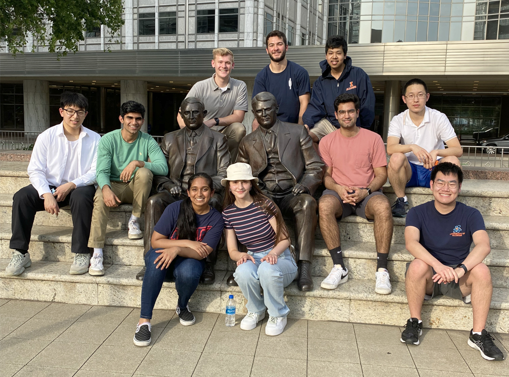 The 2022 Illinois SURF cohort pose around the Mayo Brothers statue outside Mayo Clinic in Rochester, MN